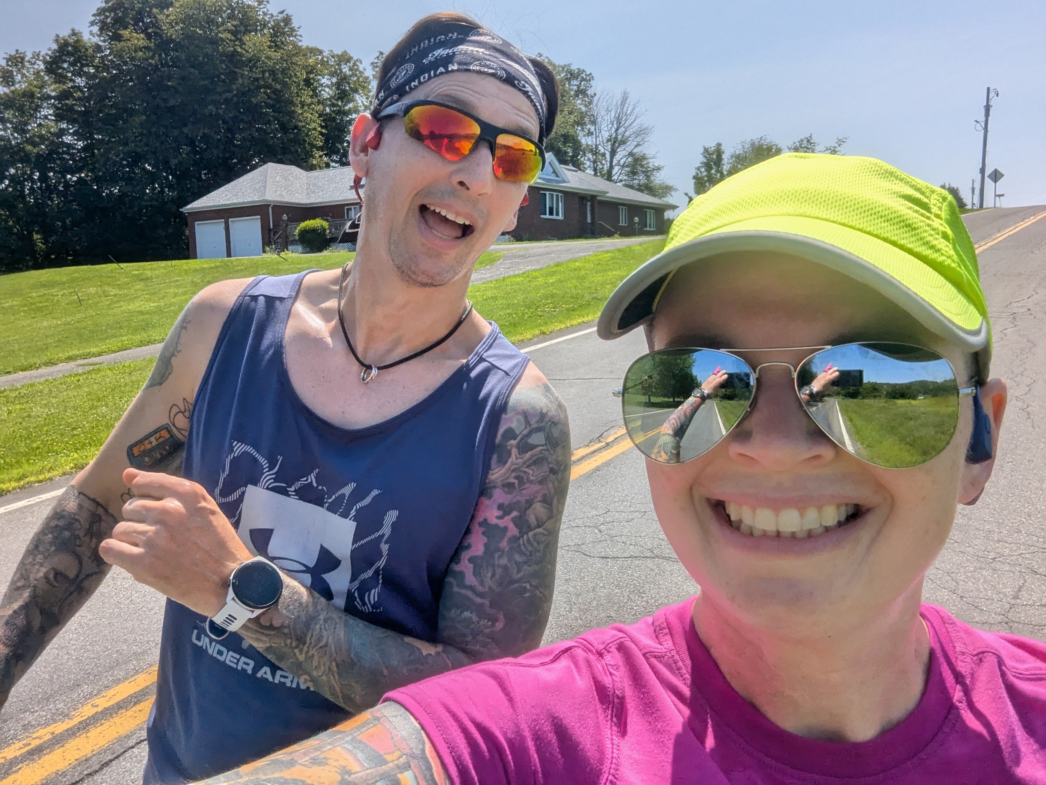 Clint and Kira out for a run on a sunny day. Kira is smiling and Clint has his mouth open as if he is surprised.